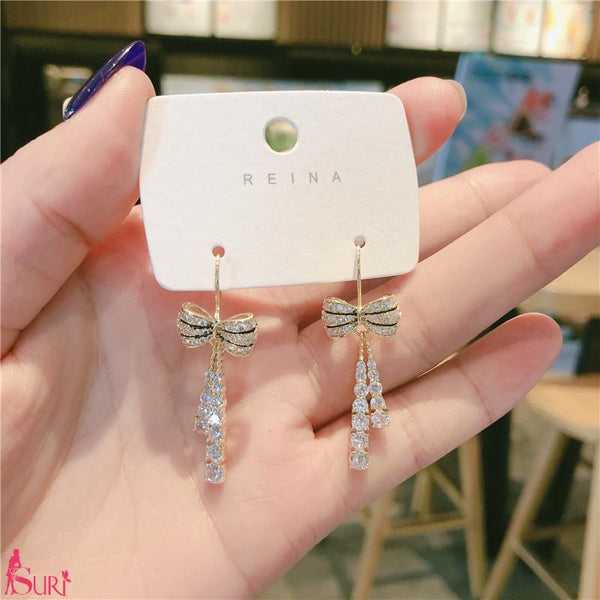 Bông Tai Tòn Teng Vàng Nơ Đá Dạng Móc